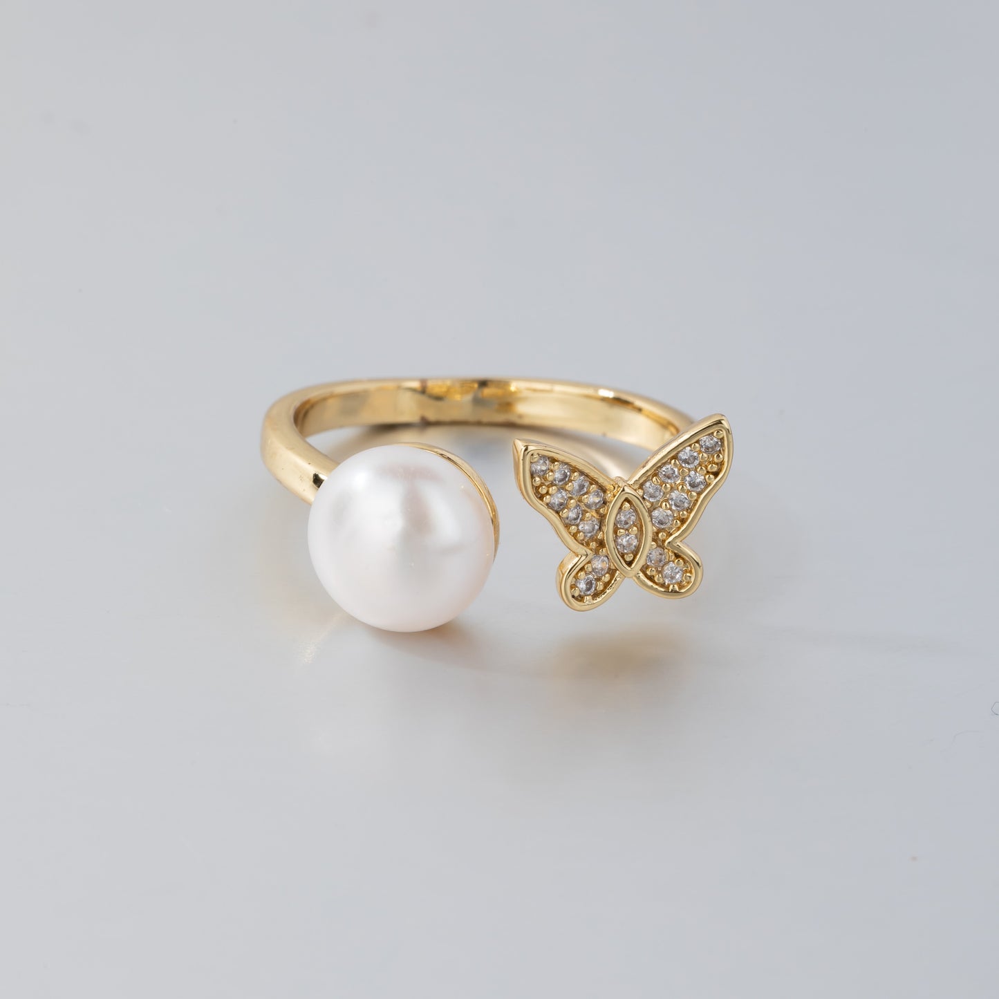 14K gold pearl butterfly ring with a large white pearl and a crystal-studded butterfly design