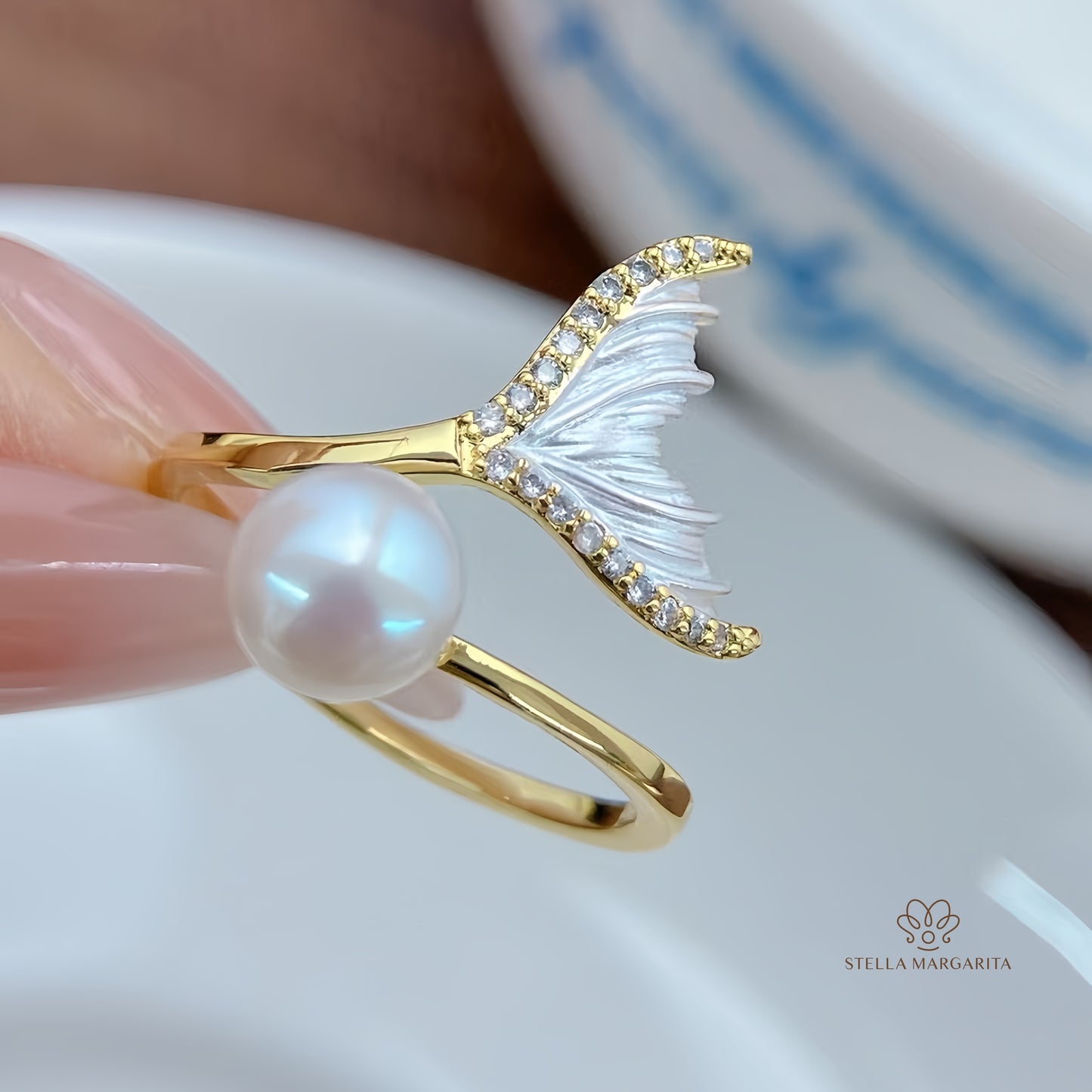 Gold adjustable pearl ring for brides featuring a pearl and delicate wing design with small crystals