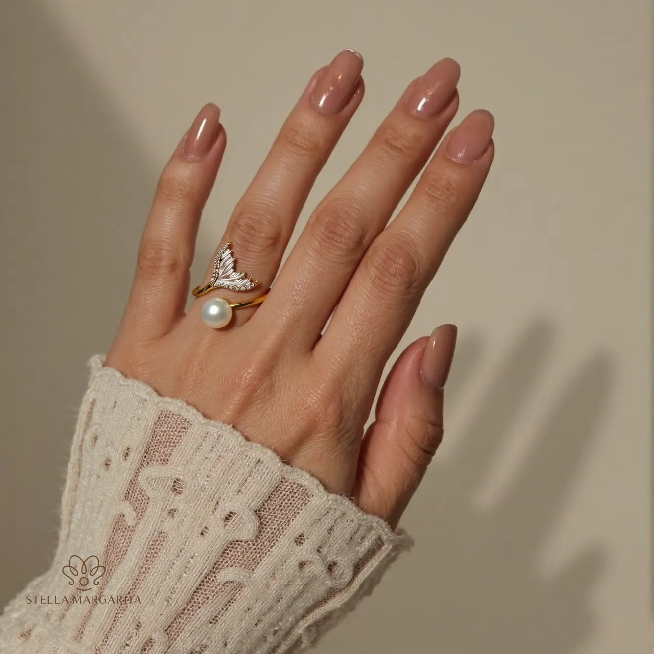 STELLA MARGARITA adjustable pearl ring for brides on hand with beige nail polish and lace sleeve