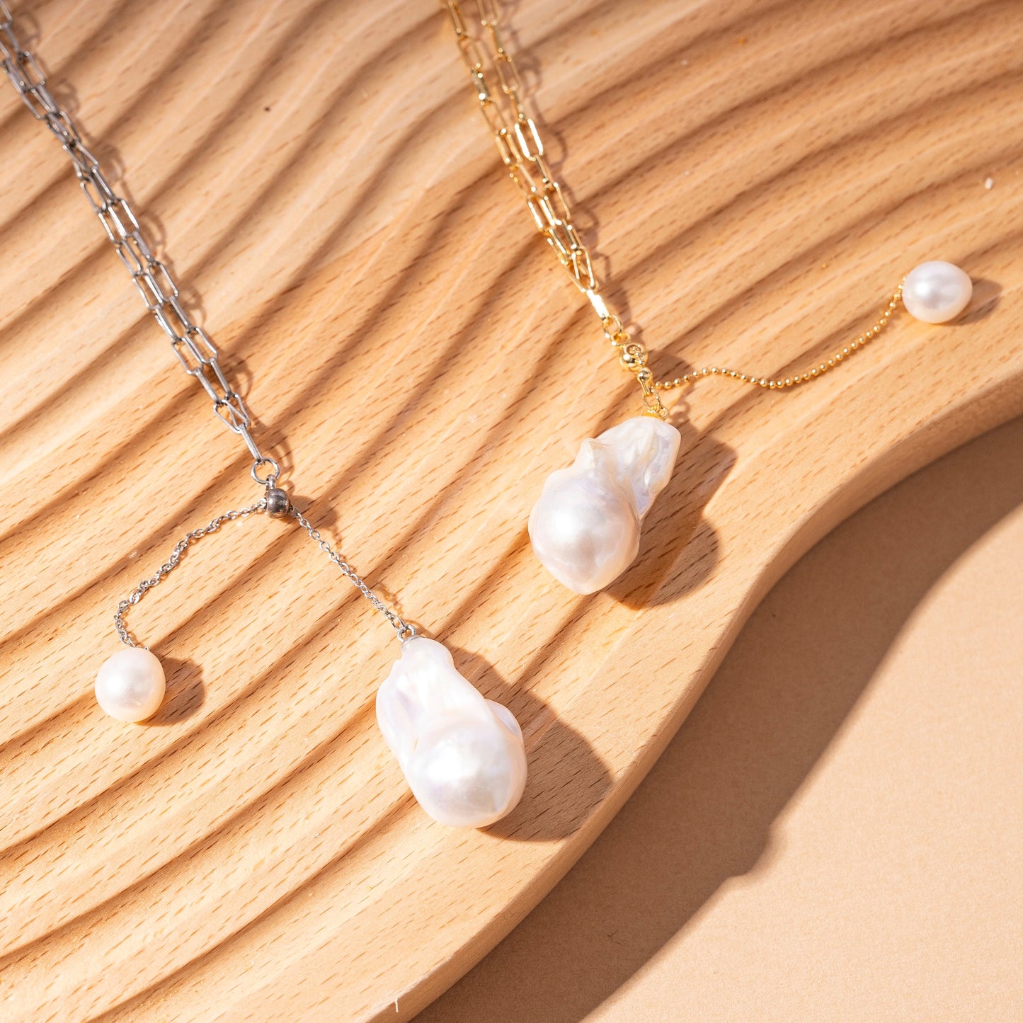 Handcrafted sterling silver pearl necklace with unique baroque pearls on silver and gold chains