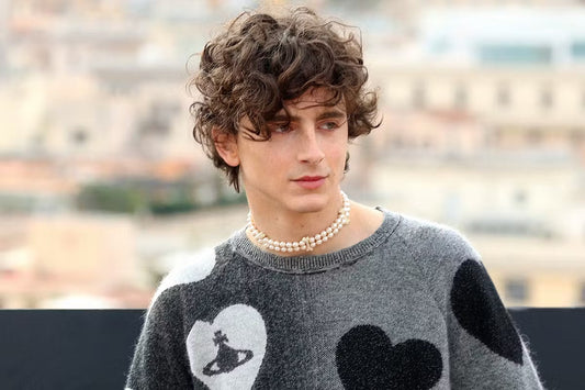 Timothee Chalamet wearing layered pearl necklaces showcasing the men's pearl jewelry trend with modern style
