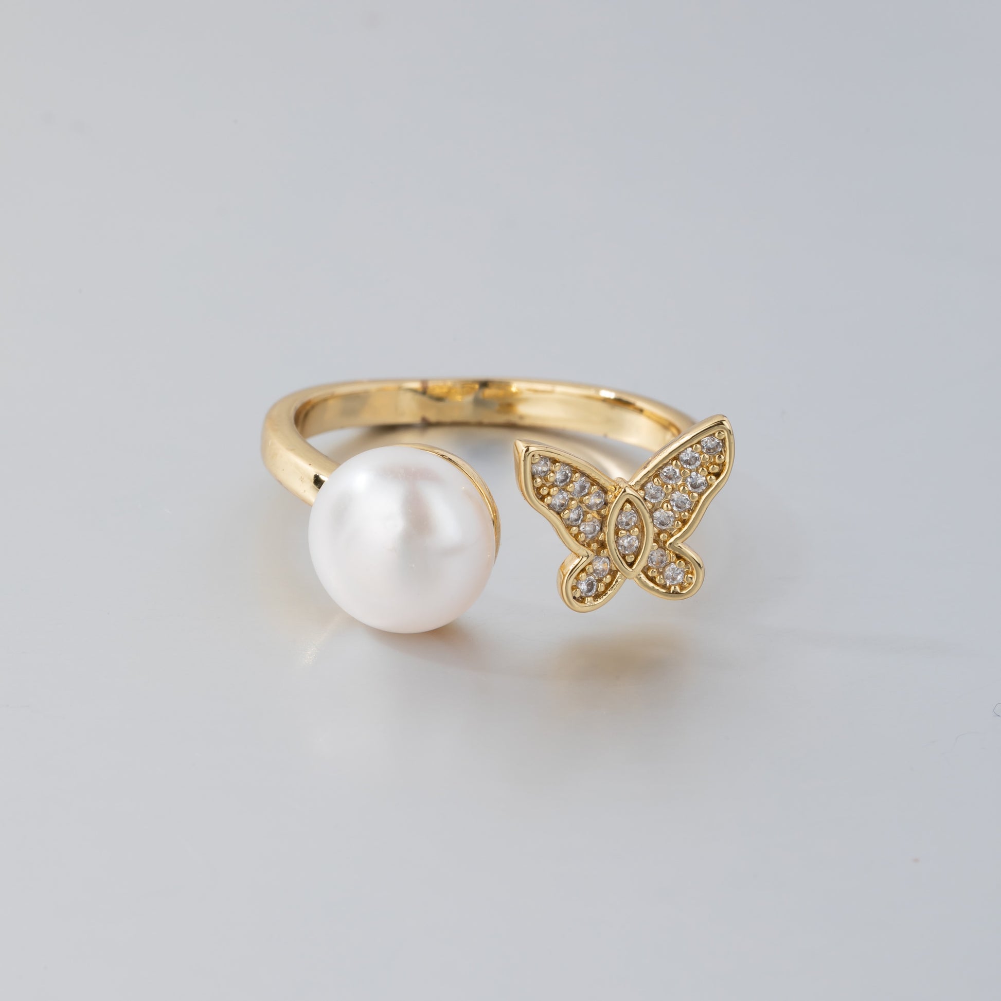 14K gold pearl butterfly ring with a large white pearl and a crystal-studded butterfly design