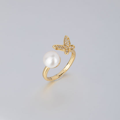 STELLA MARGARITA 14K gold pearl butterfly ring featuring a white pearl and a butterfly design