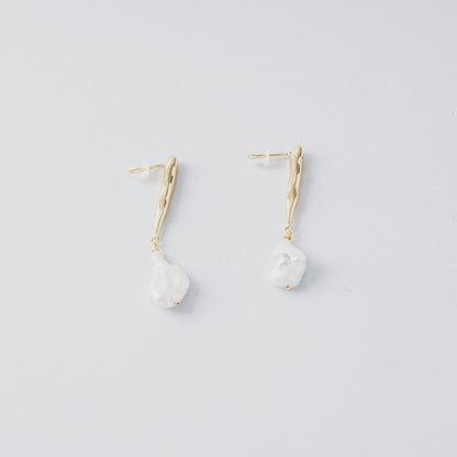 STELLA MARGARITA baroque pearl drop earrings with gold textured hooks on white background