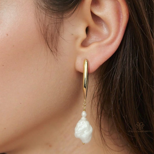 STELLA MARGARITA gold baroque pearl drop earrings worn on ear with elegant design