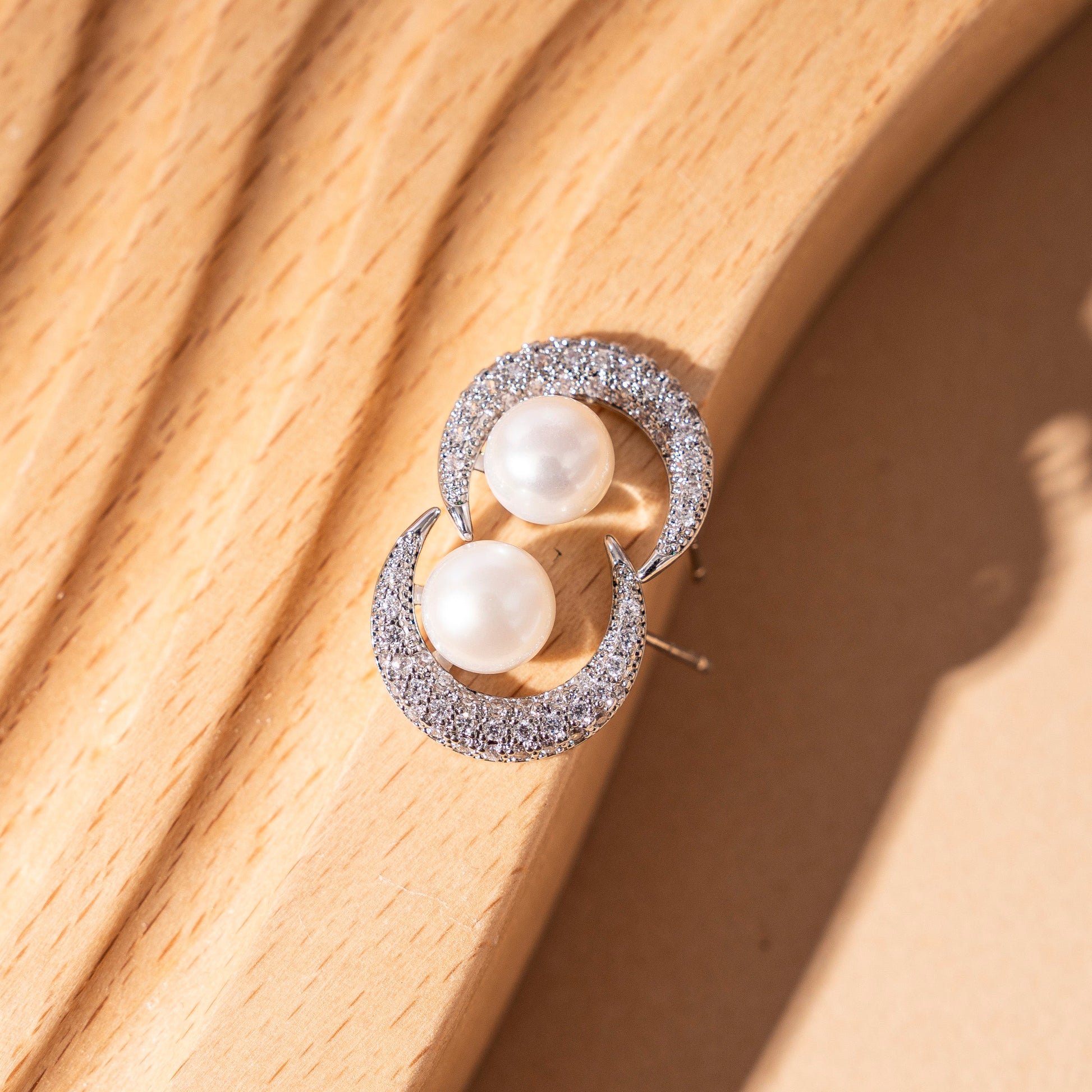 STELLA MARGARITA celestial moon pearl earrings with crescent moon design and sparkling stones