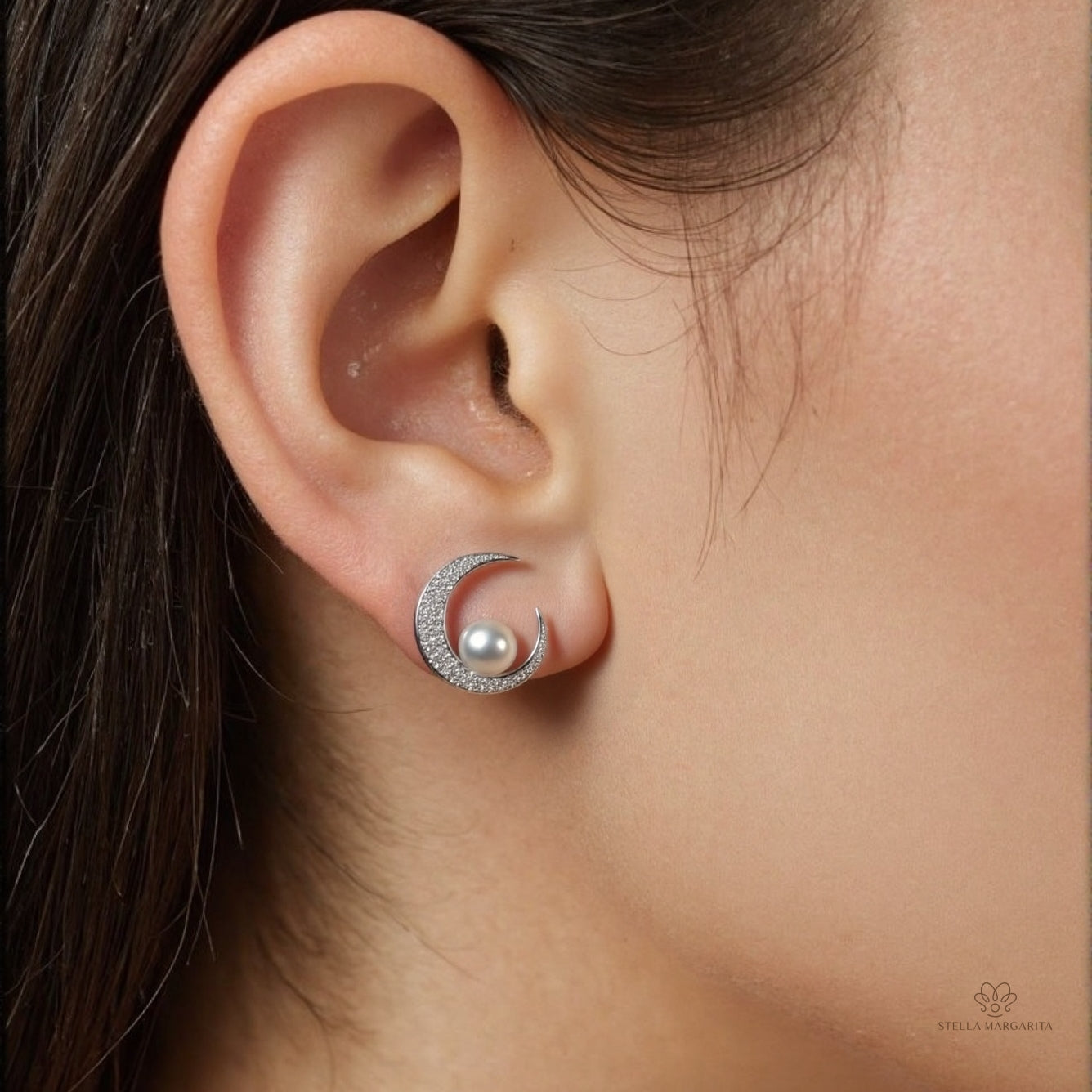 STELLA MARGARITA celestial moon pearl earrings with crescent moon design and pearl worn on ear