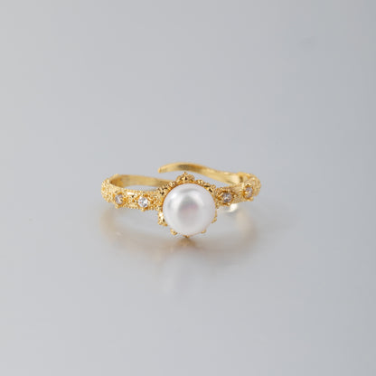 Handcrafted gold pearl engagement ring with ornate band and central white pearl by STELLA MARGARITA