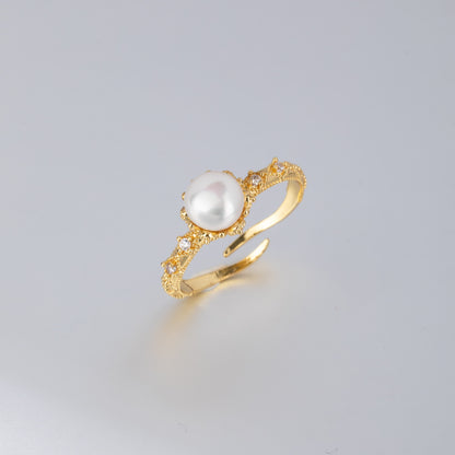Handcrafted gold pearl engagement ring featuring a central white pearl and intricate gold detailing