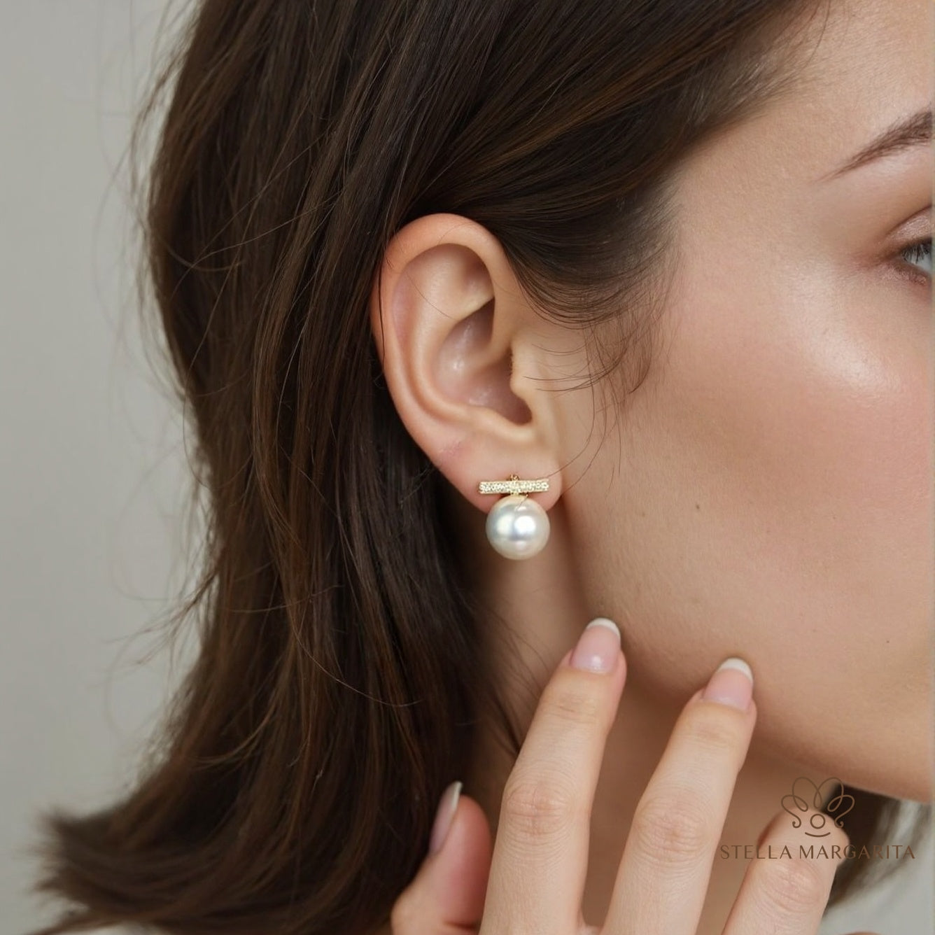 STELLA MARGARITA balance beam pearl stud earrings worn on ear with gold bar and white pearl drop