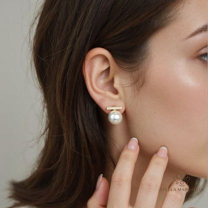STELLA MARGARITA balance beam pearl stud earrings worn on ear with gold bar and white pearl drop