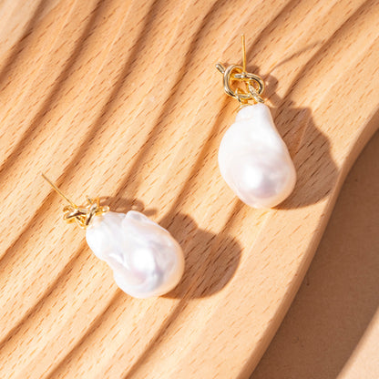 STELLA MARGARITA elegant baroque freshwater pearl earrings with gold hooks on wooden surface
