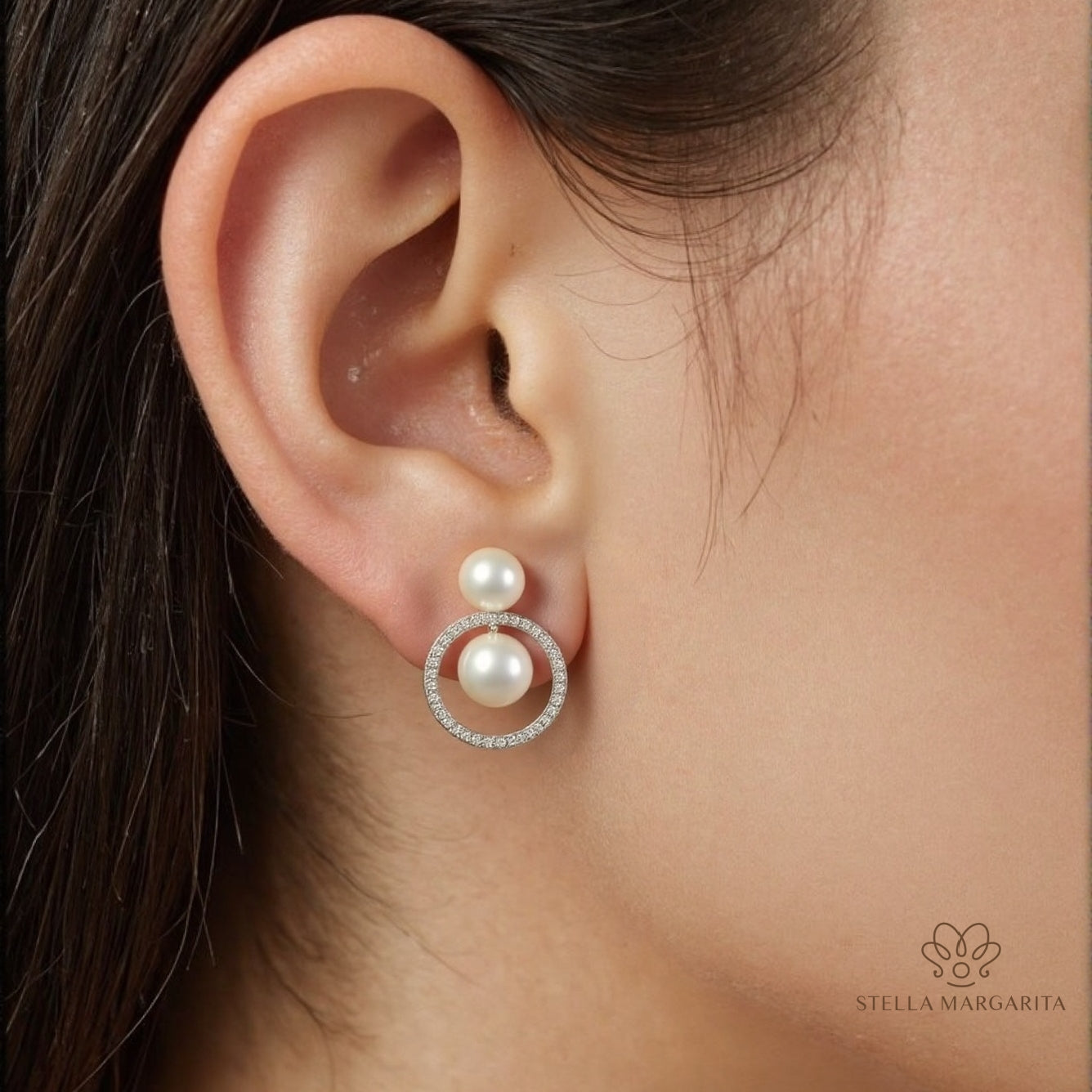 STELLA MARGARITA double freshwater pearl earrings with a diamond-studded circle detail worn on ear